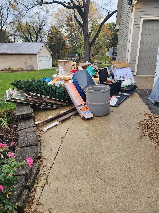 Dumpster being loaded with debris for Roofing Dumpster Rental in O'Fallon
